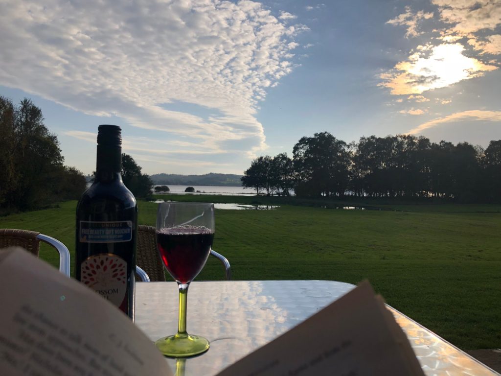 Looking out to the Loch in Autumn with a good book and a glass of wine on the private terrace at Loch Lomond Waterftont