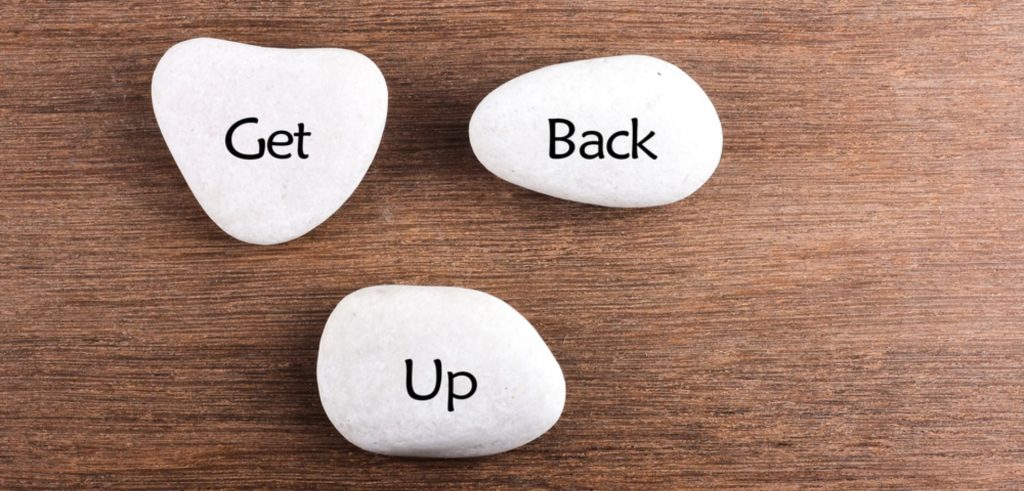 Get Back Up written on white pebbles