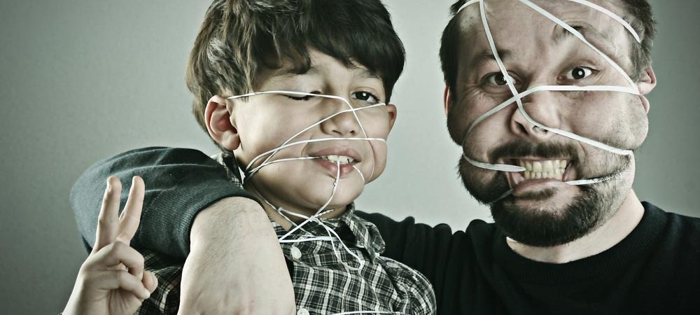A man and boy with rubber bands on their faces