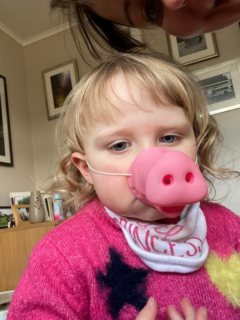 Millie with a pig nose mask on