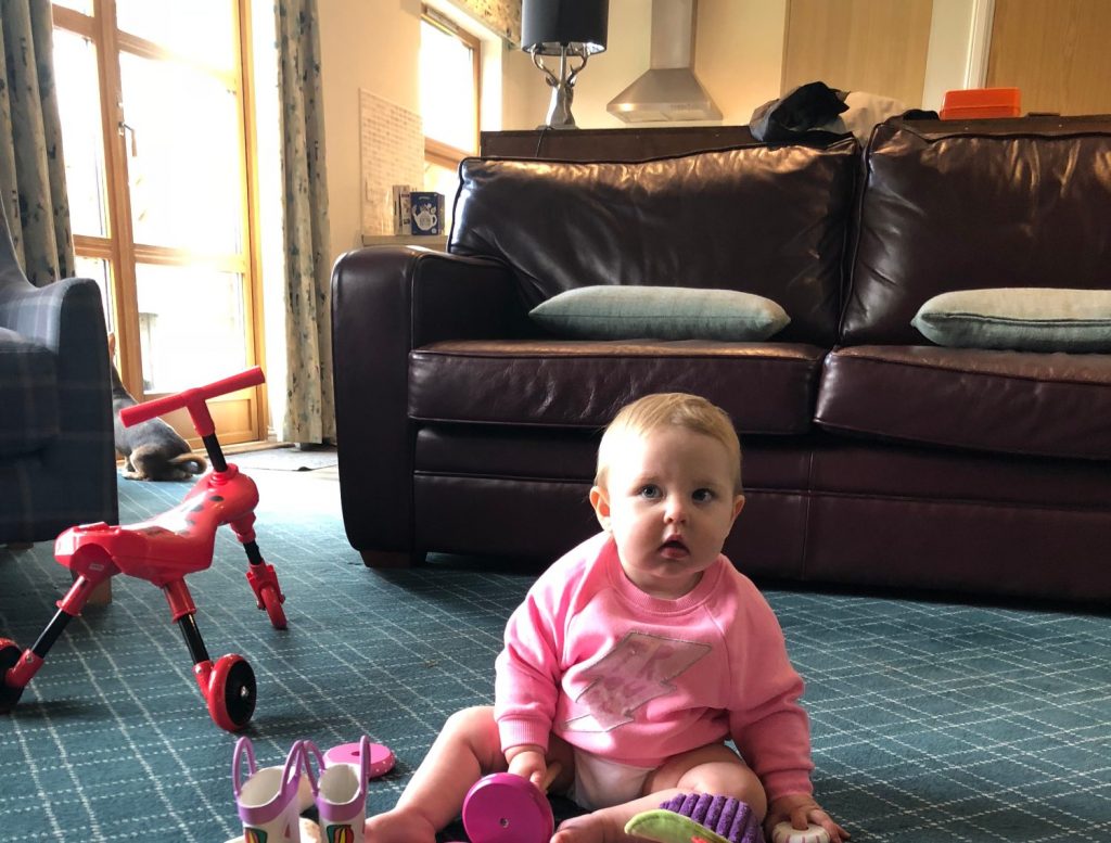 Millie Mills aged 1 on holiday at Loch Lomond Waterfront sitting in the lounge with her toys.