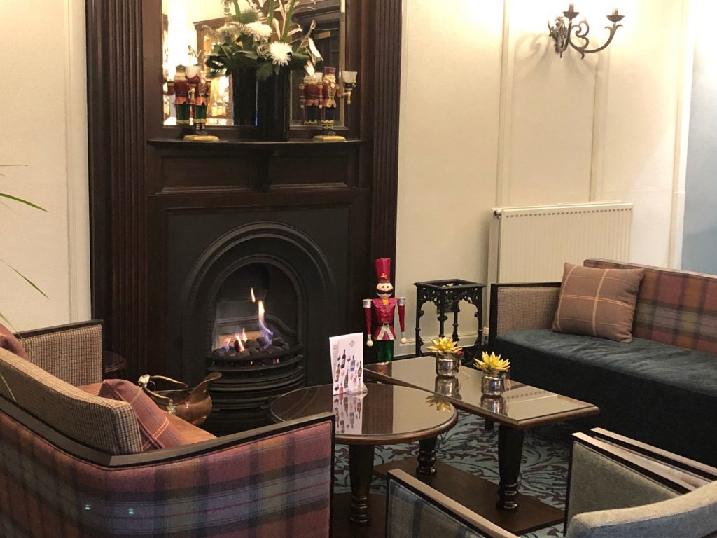 Parliament House hotel lounge with the fire on decorated for Christmas in edinburgh