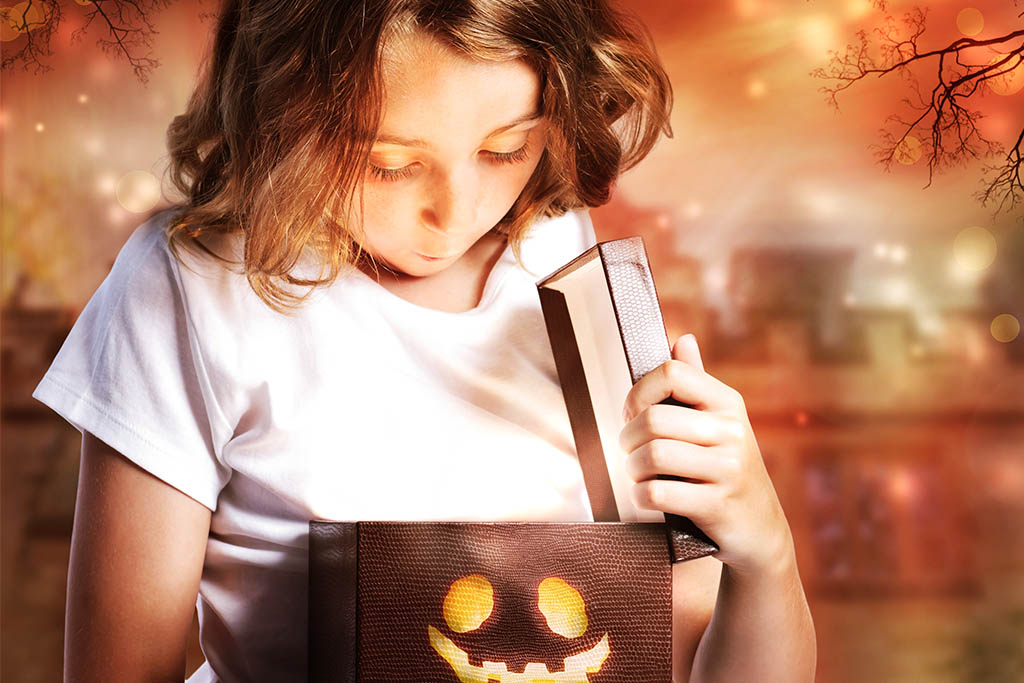 a girl looking into a pumpkin box