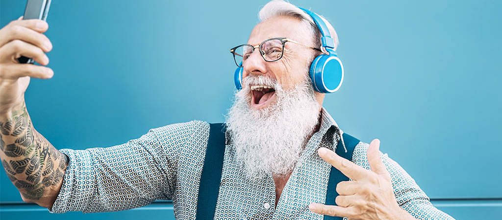 an old man happy watching Tik Tok videos