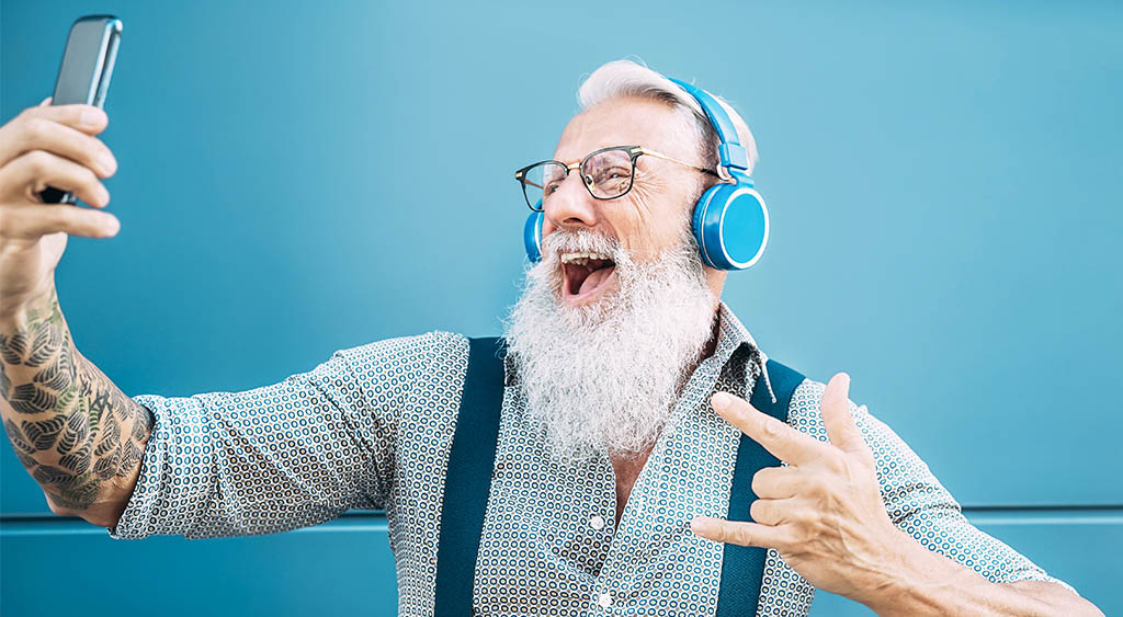 an old man happy watching Tik Tok videos