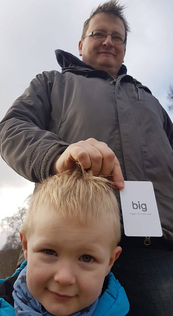 using gofindit cards is a man and a boy, the card says 'big' on it.