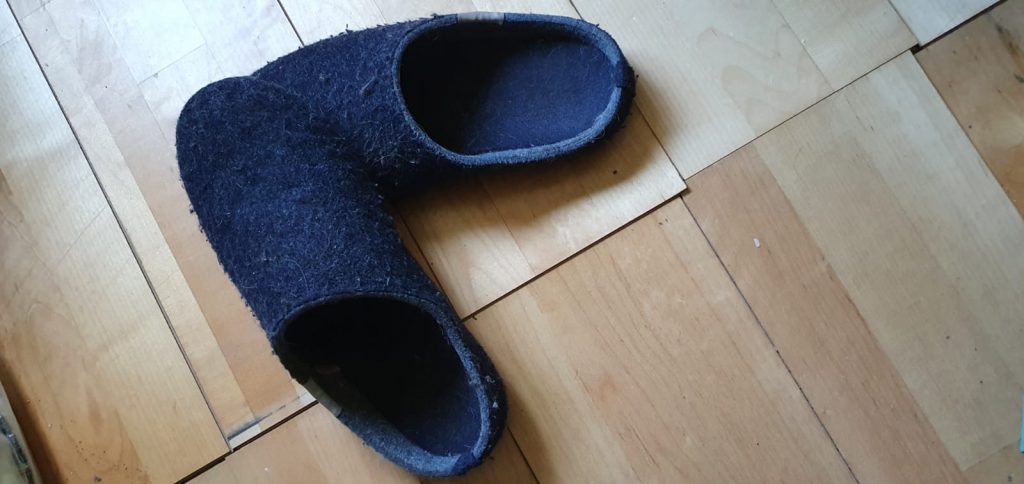 Blue Gumbies slippers crossed from above