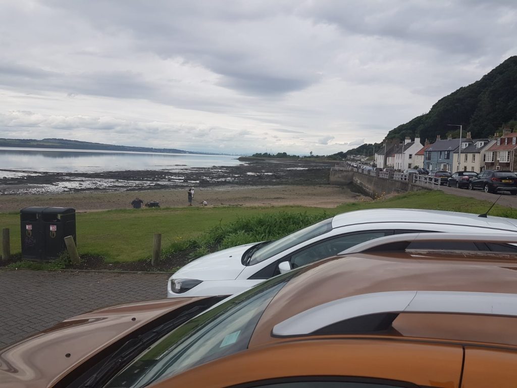 cars parked by the beachside at Limekilns