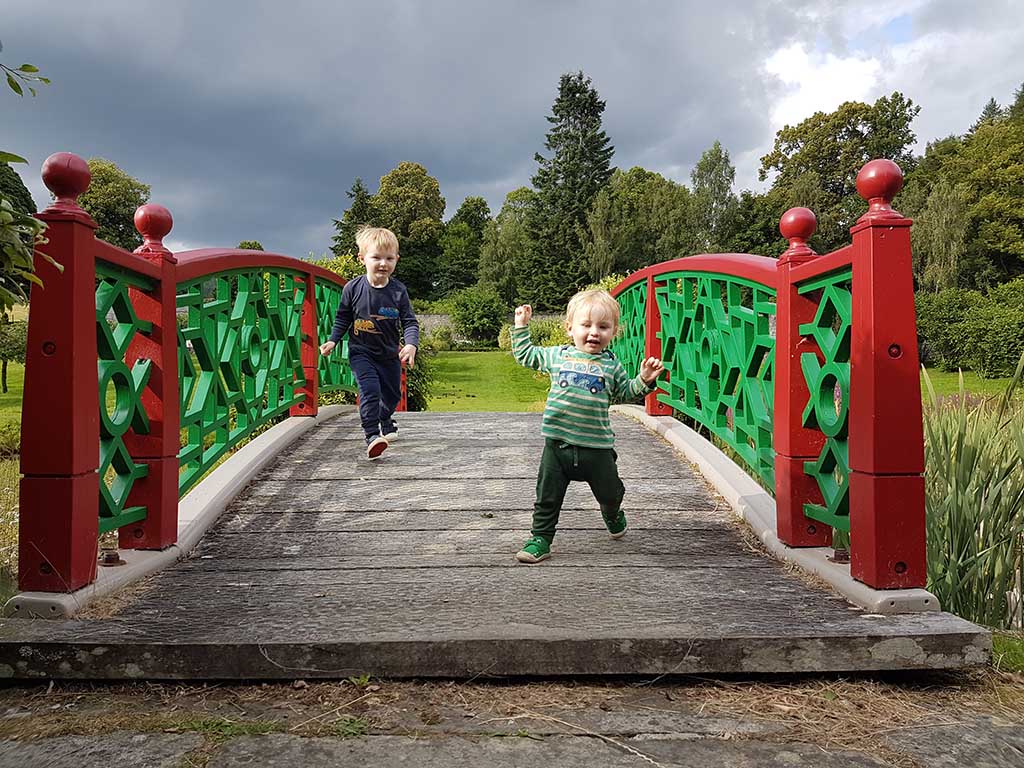 boys running across the bridge